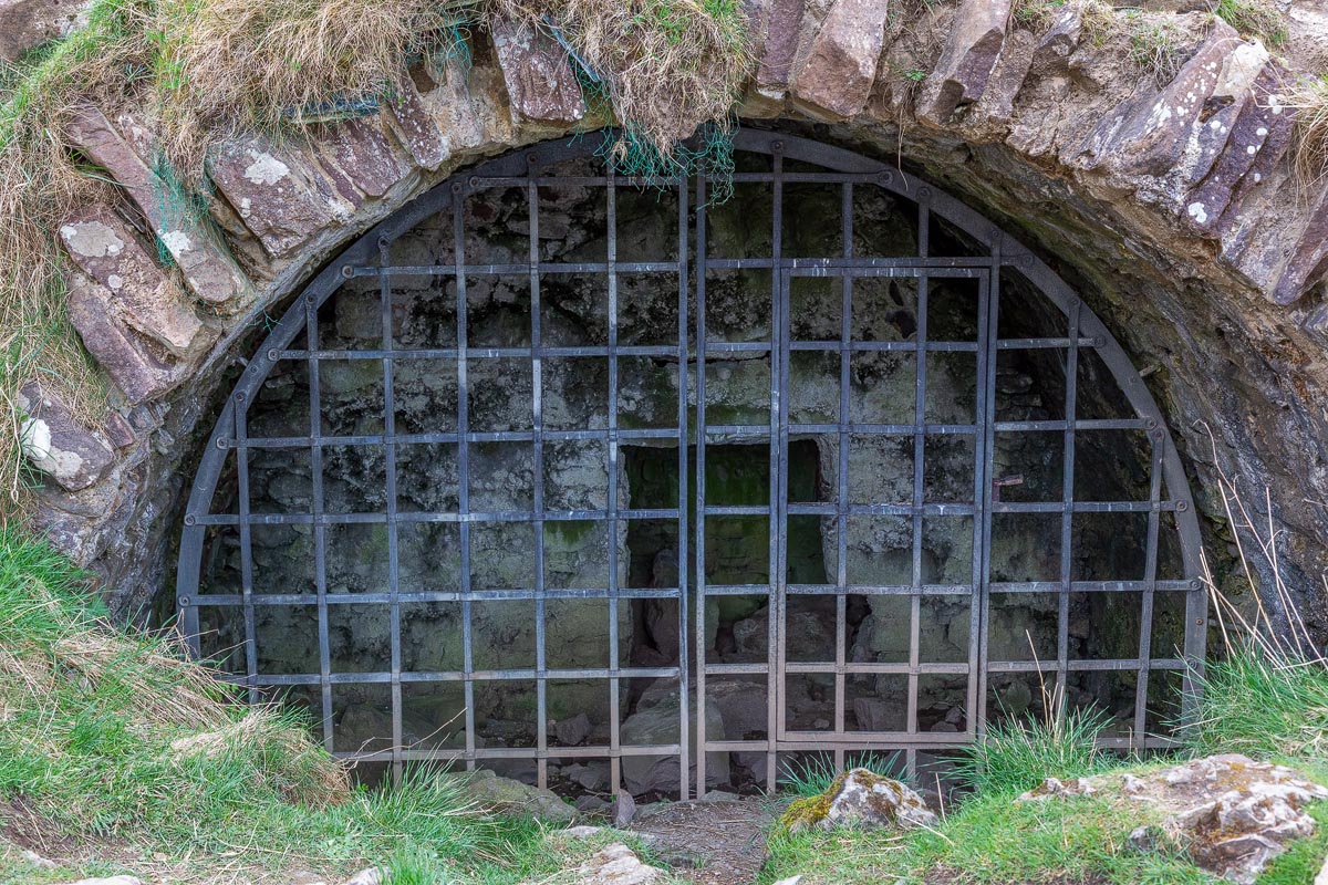 The iron grille covering the entrance to the vaulted basement cellar at Ardvreck Castle