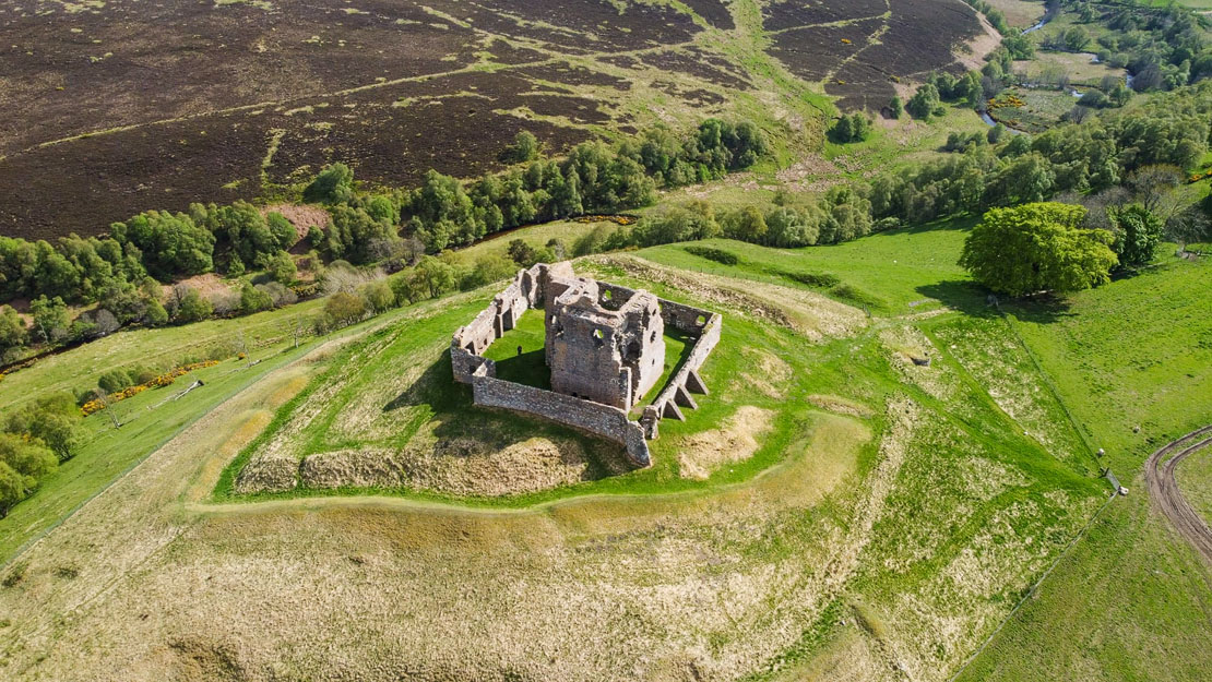 The setting of Auchindoun from the air, showing man made earthworks.