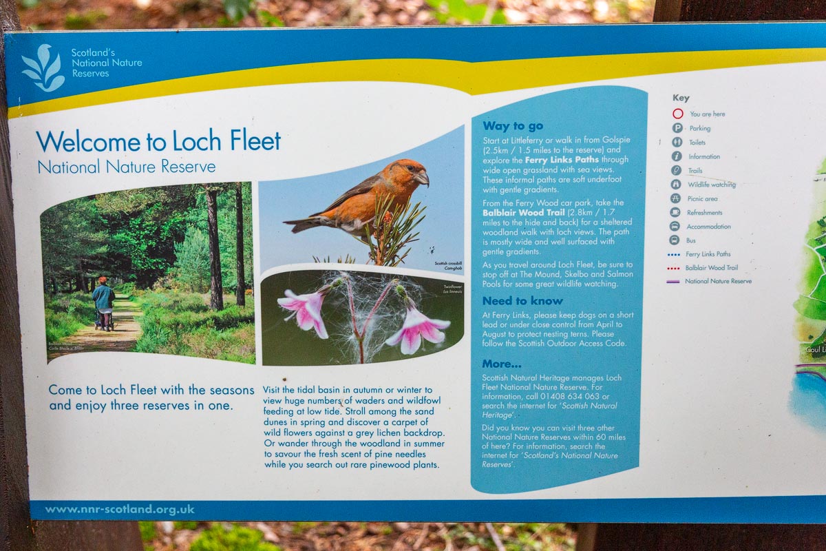 Close-up of the Welcome to Loch Fleet National Nature Reserve information board showing trail details and wildlife