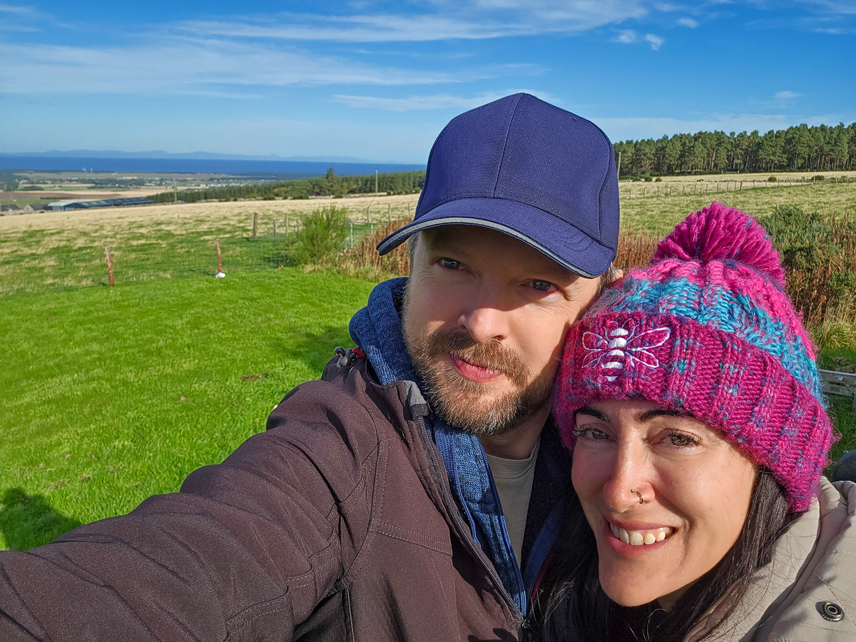 Chris and Janette taking a selfie at Califer Hill with the Moray Firth behind them