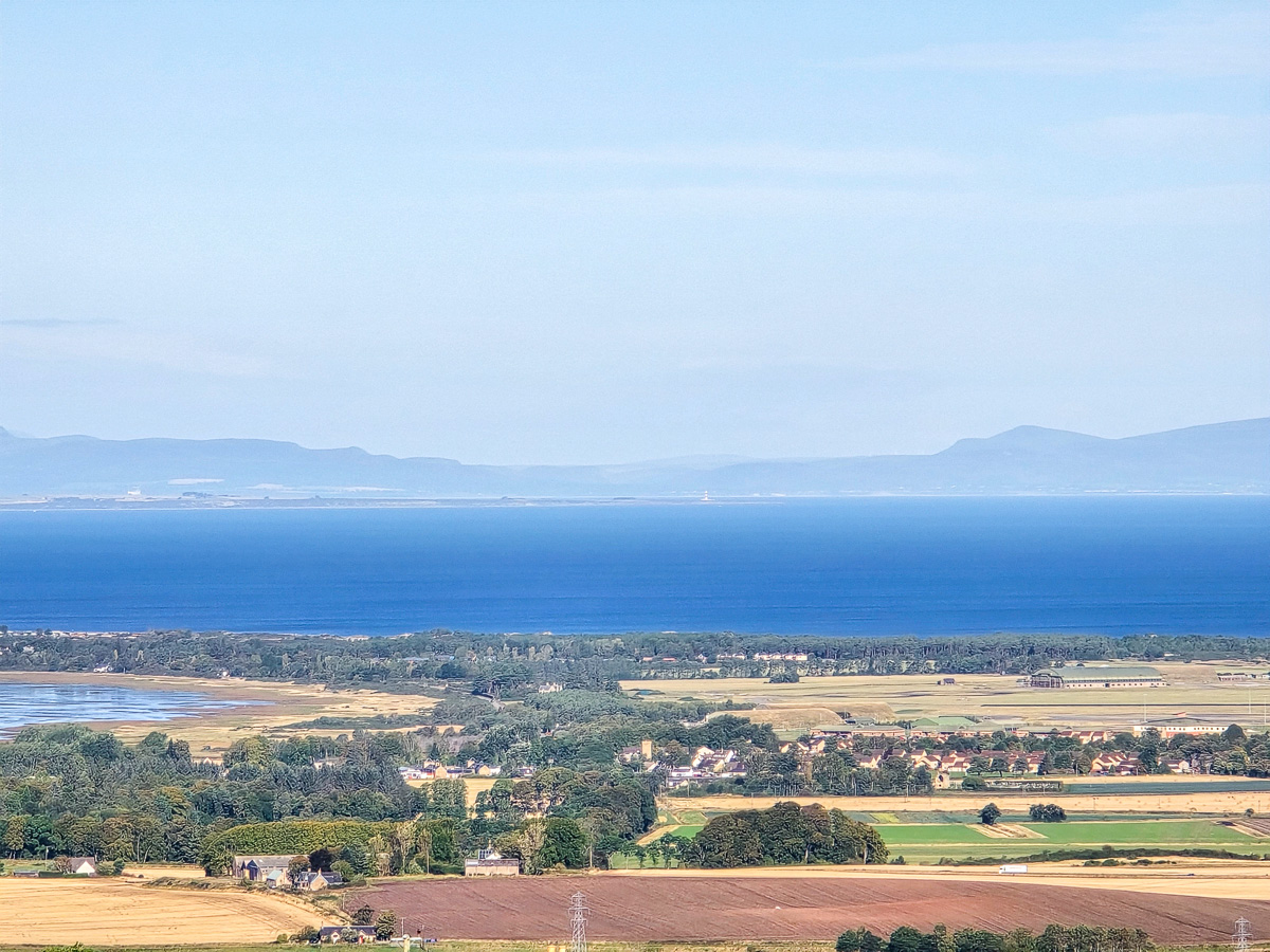 Kinloss below with Tarbat Ness Lighthouse a small white tower on the far shore of the Moray Firth