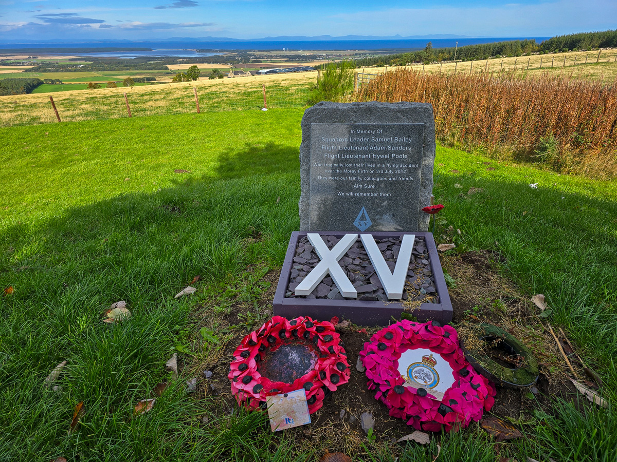 XV Squadron memorial stone with poppy wreaths at Califer Hill overlooking the Moray Firth