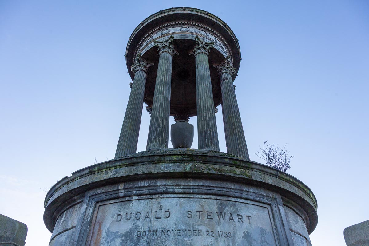 Close-up of the Dugald Stewart Monument showing the inscription and Corinthian columns from below