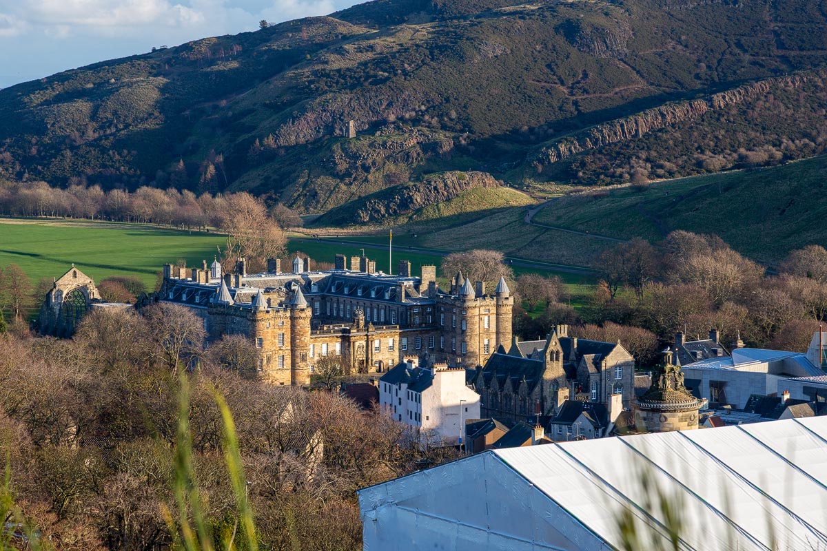 The Palace of Holyroodhouse viewed from Calton Hill, nestled beneath Arthur's Seat