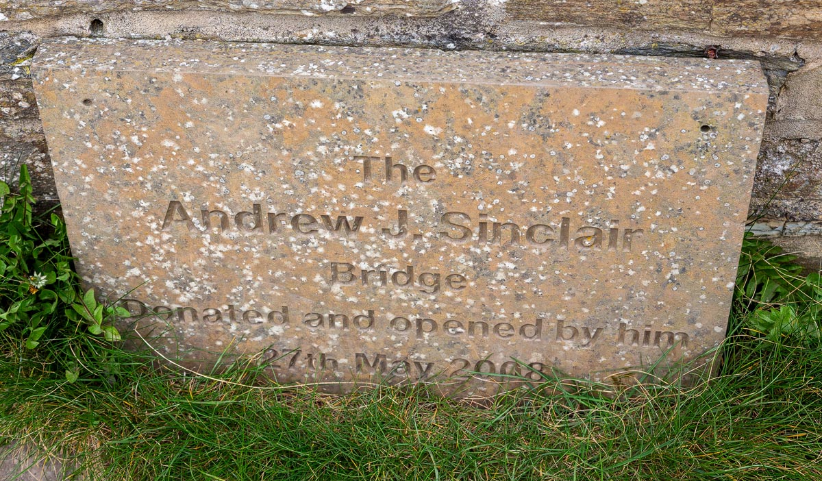 Stone plaque reading The Andrew J. Sinclair Bridge, Donated and opened by him 27th May 2008