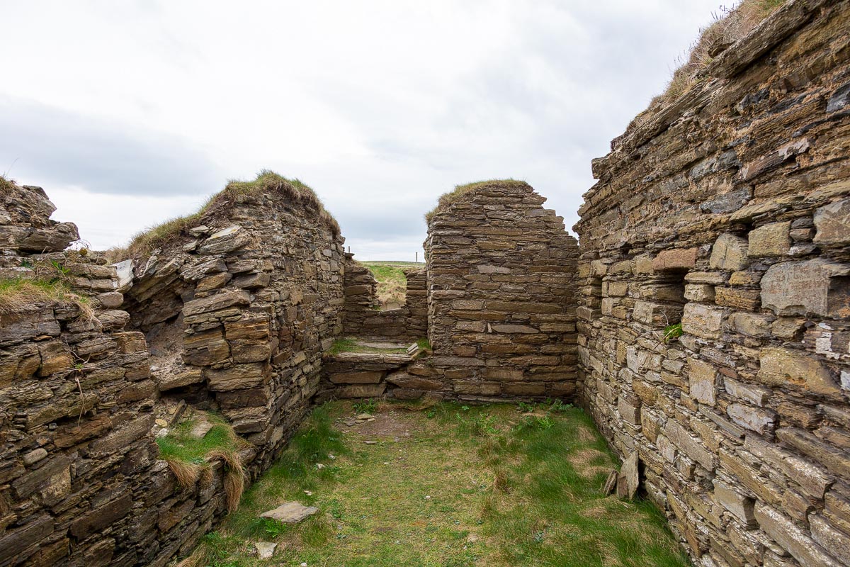 Inside the ruined rooms of Castle Sinclair Girnigoe showing Caithness flagstone walls with doorways and window openings