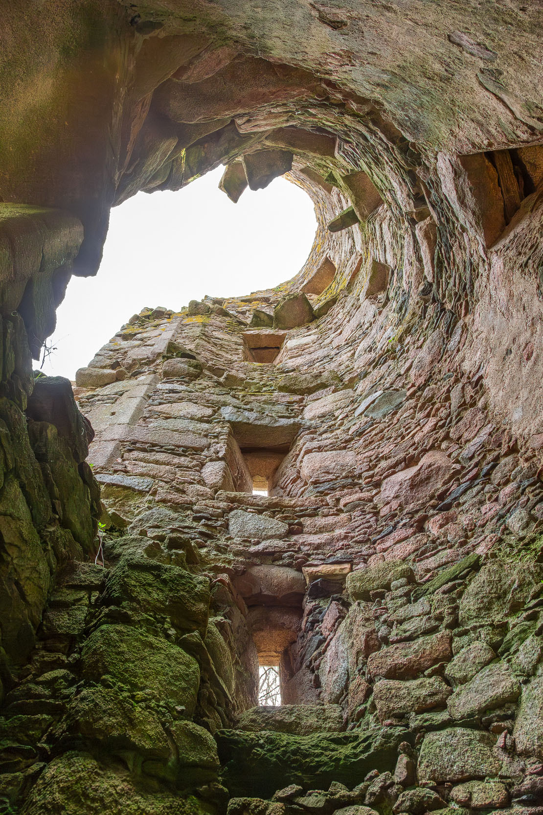 A dramatic view looking up through the stair tower to the open sky