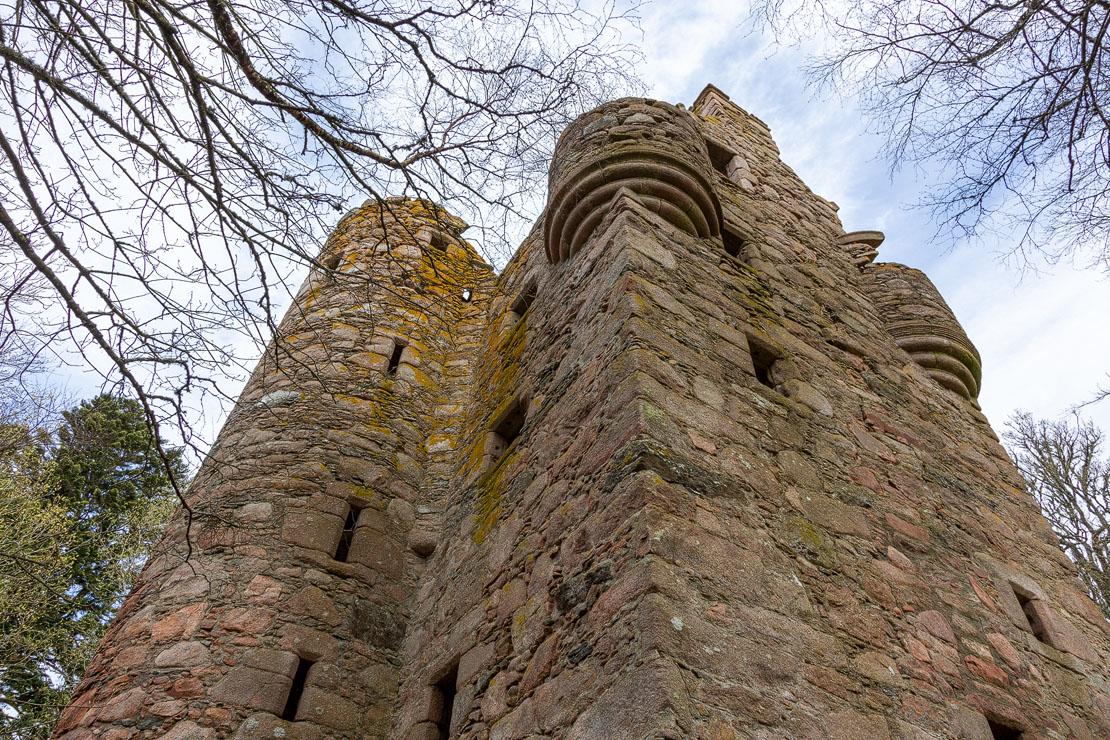 Looking up at the tower with both corbelled turrets visible against the sky