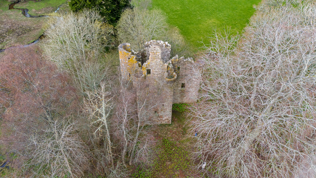 Aerial view showing the castle and the Corse Burn which once formed a defensive lochan