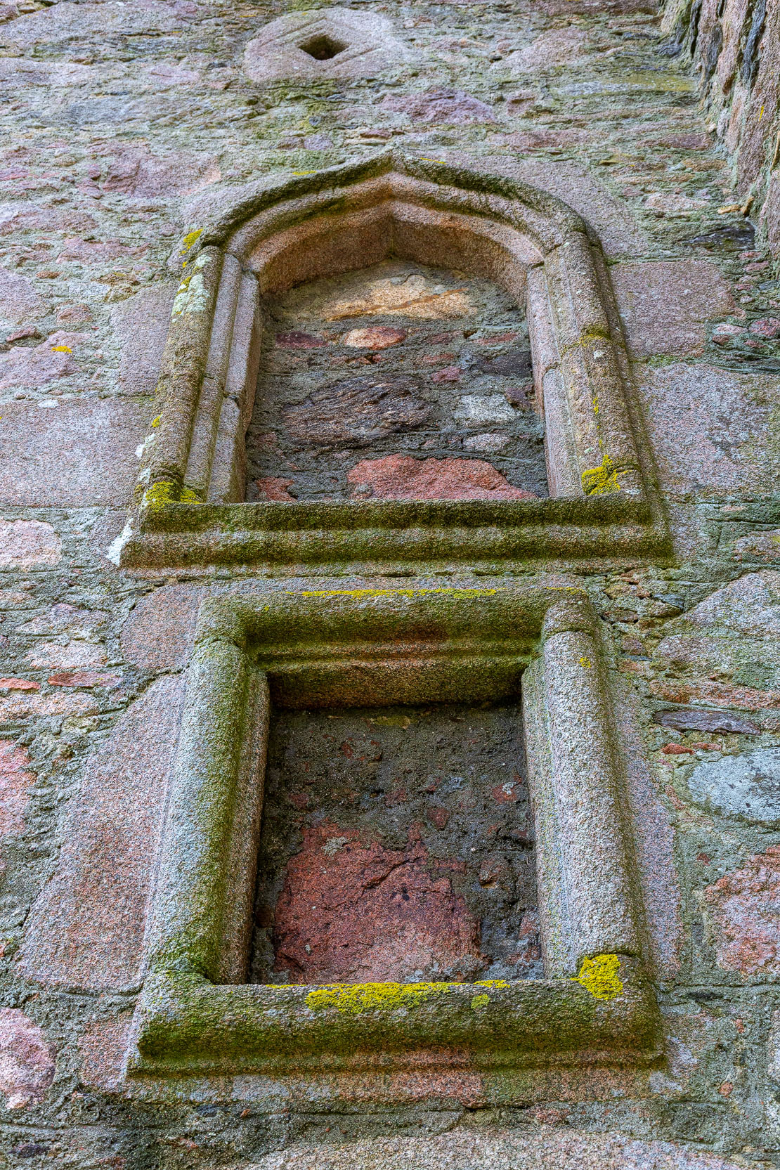 Decorative window surround with a gunloop visible above – combining comfort with defence