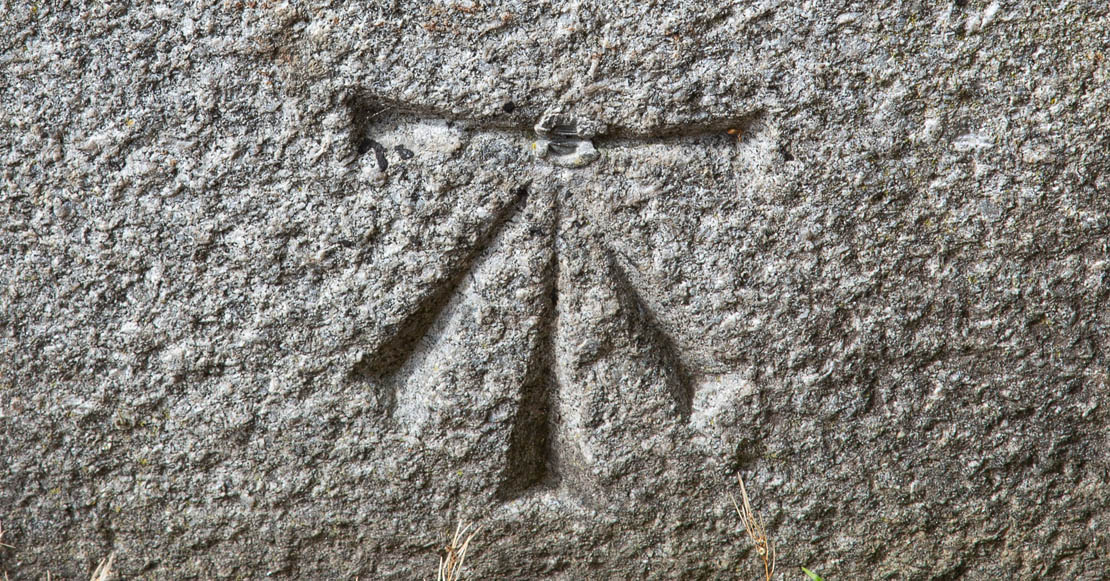 Ordinance survey benchmark carved into the rock.