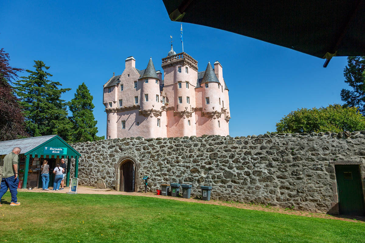 Craigievar Castle viewed from behind the old barmkin wall with the Barmkin Kiosk and stone archway in the foreground