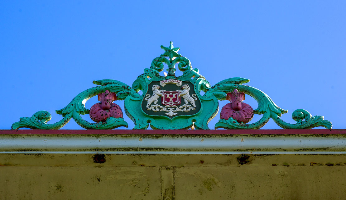 Close-up detail of the Aberdeen coat of arms cartouche on the Duthie Park bandstand showing the Bon Accord motto