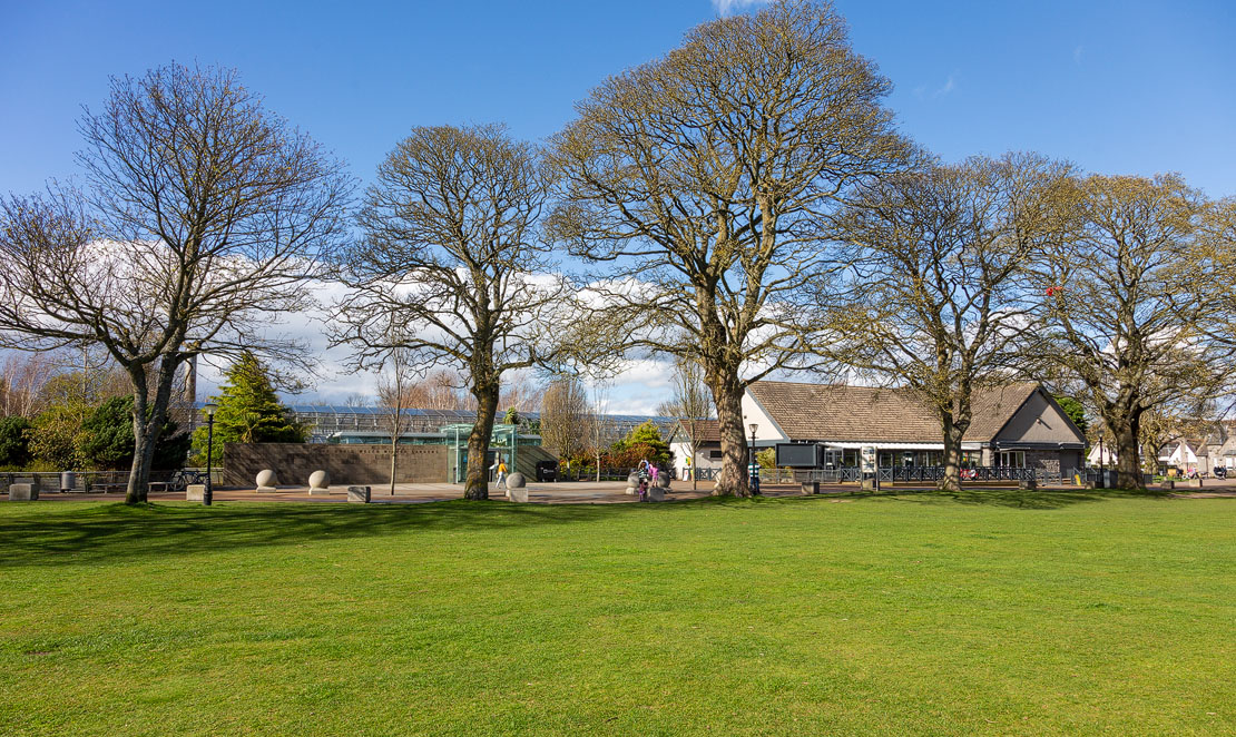 The David Welch Winter Gardens entrance and Park Café viewed across the central green at Duthie Park, Aberdeen
