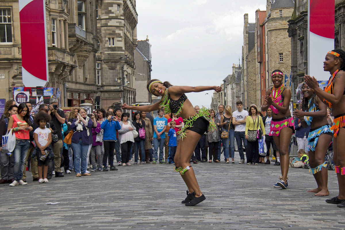 Street performers entertaining crowds on the Royal Mile during the Edinburgh Festival Fringe