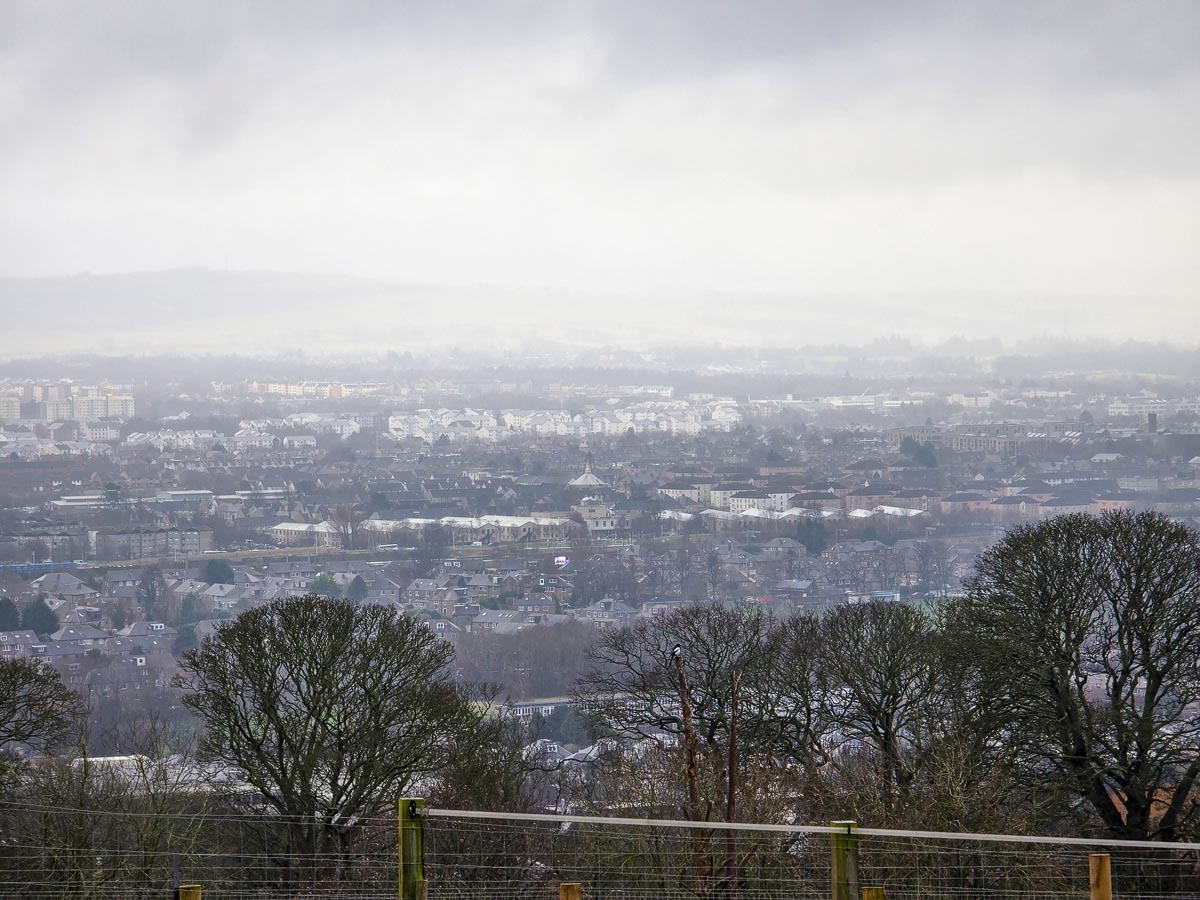 Panoramic view across Edinburgh from the upper slopes of Edinburgh Zoo on an overcast day