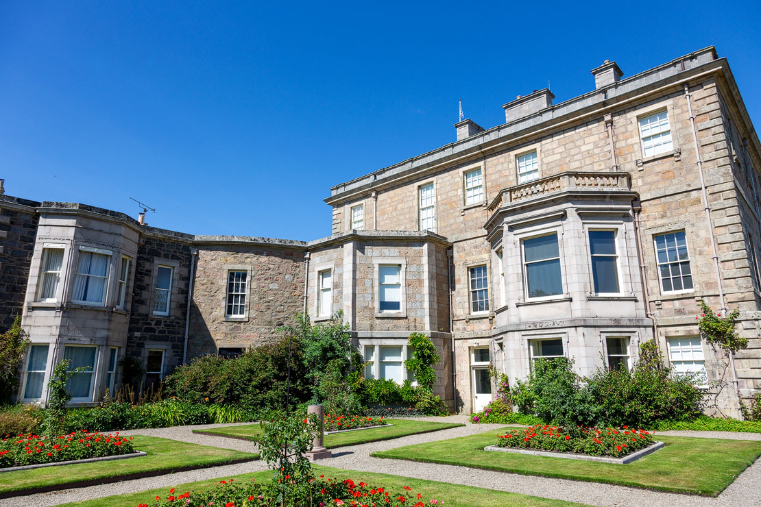 The side of Haddo House with a formal rose garden