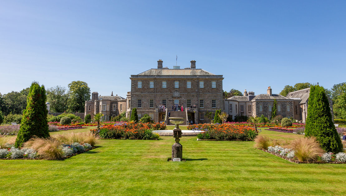 Haddo House viewed from the formal gardens with sundial and colourful borders