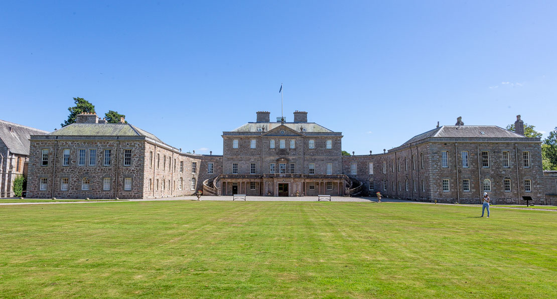The full front façade of Haddo House showing the central block and curved wings
