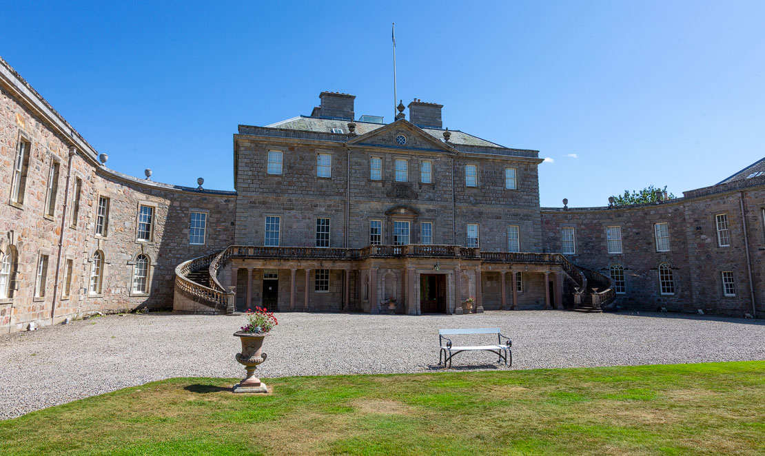 The front courtyard of Haddo House with decorative urn and bench