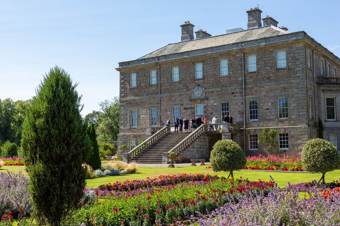 Haddo House from the terrace gardens with colourful flower beds in bloom