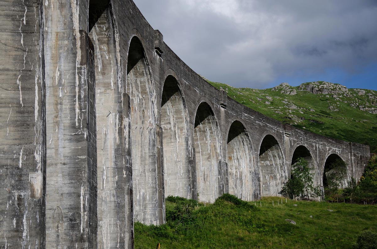 Close-up view of the Glenfinnan Viaduct's 21 arches against the Highland backdrop