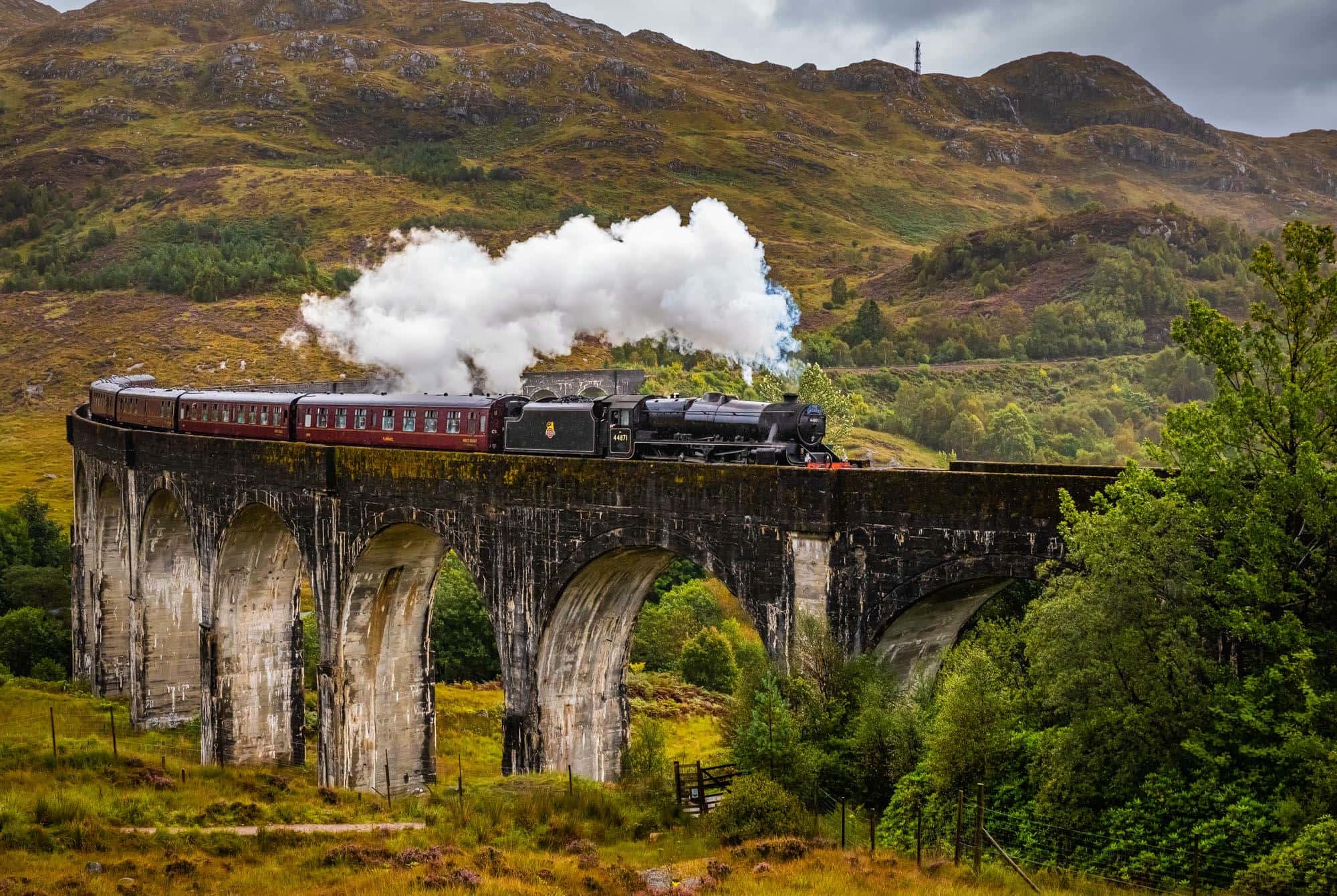 The Jacobite steam train, known as the Hogwarts Express, travelling through the Scottish Highlands
