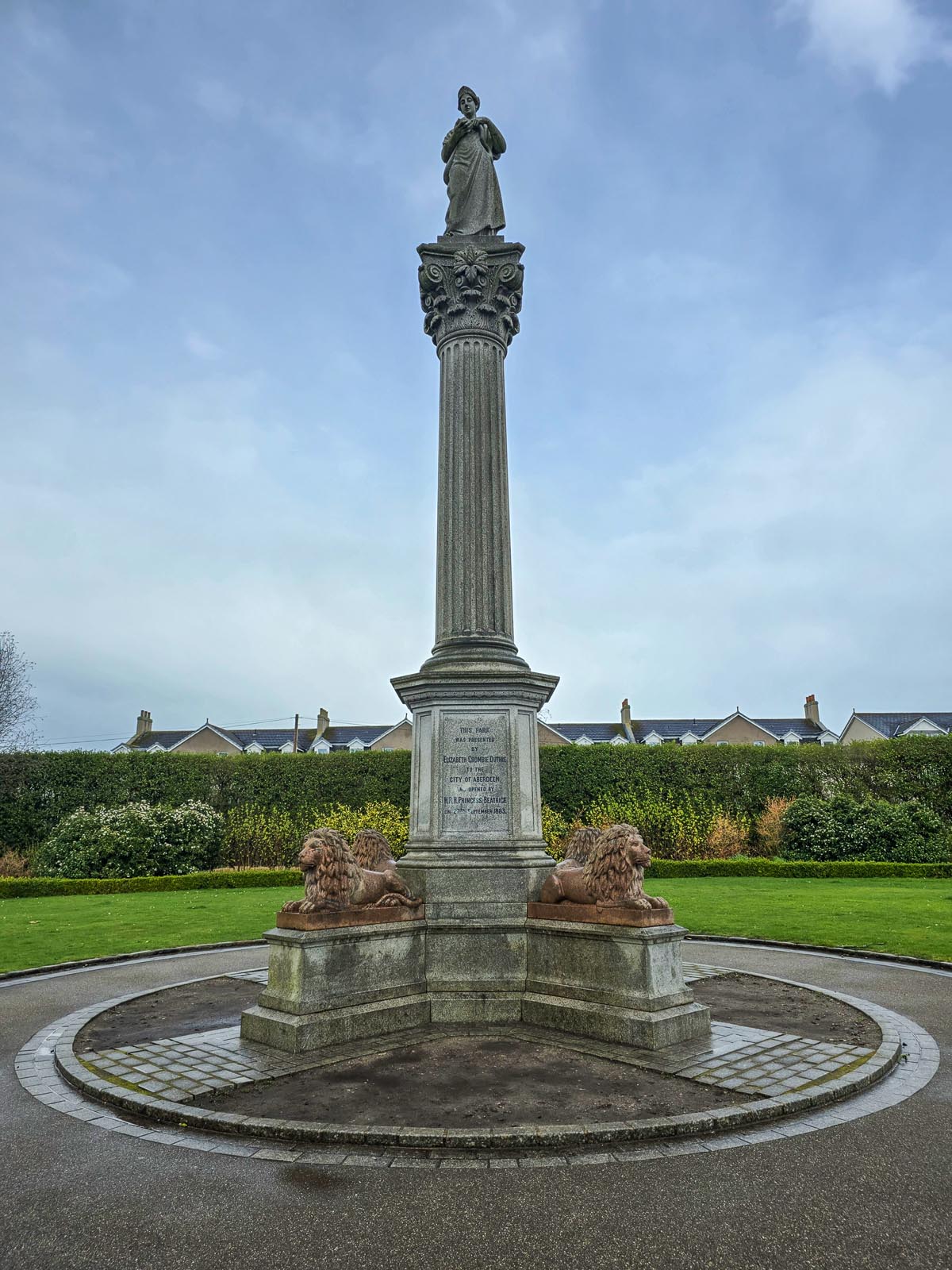Front view of the Hygeia Monument showing the inscription plinth, pink granite lions, fluted Corinthian column and statue of Hygeia
