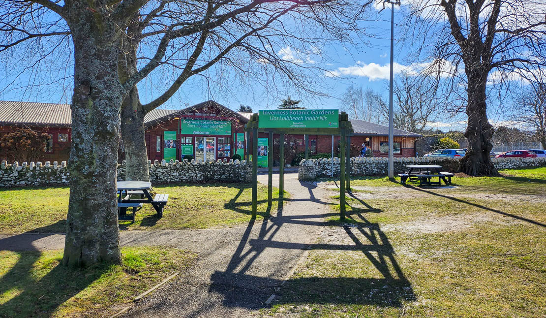 Entrance to Inverness Botanical Gardens with picnic tables.