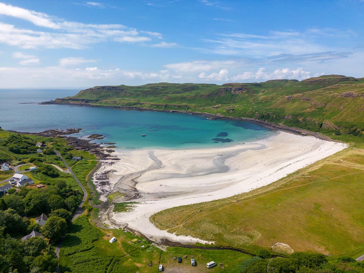 Aerial view of Calgary Bay on the Isle of Mull showing white sand and turquoise water surrounded by green headlands
