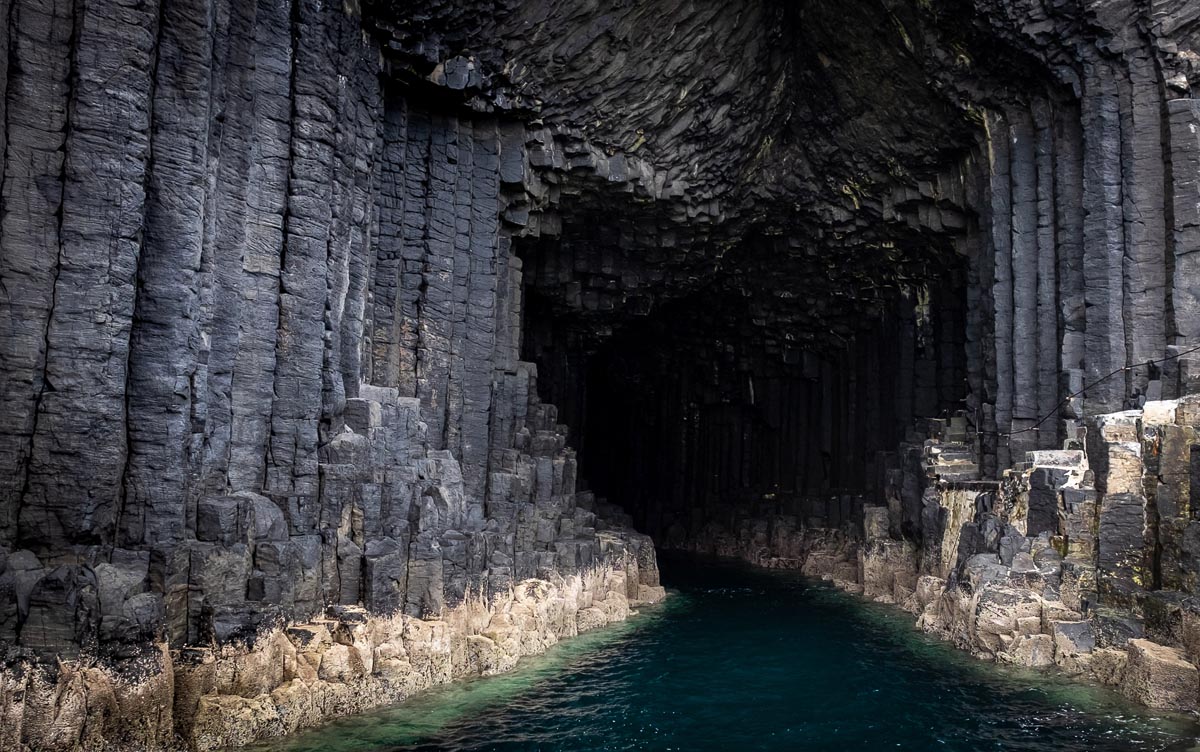 The entrance to Fingal''s Cave on the Isle of Staffa showing hexagonal basalt columns rising from turquoise water