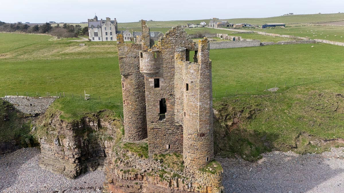 Aerial view showing both Old Keiss Castle in the foreground and New Keiss Castle mansion in the background