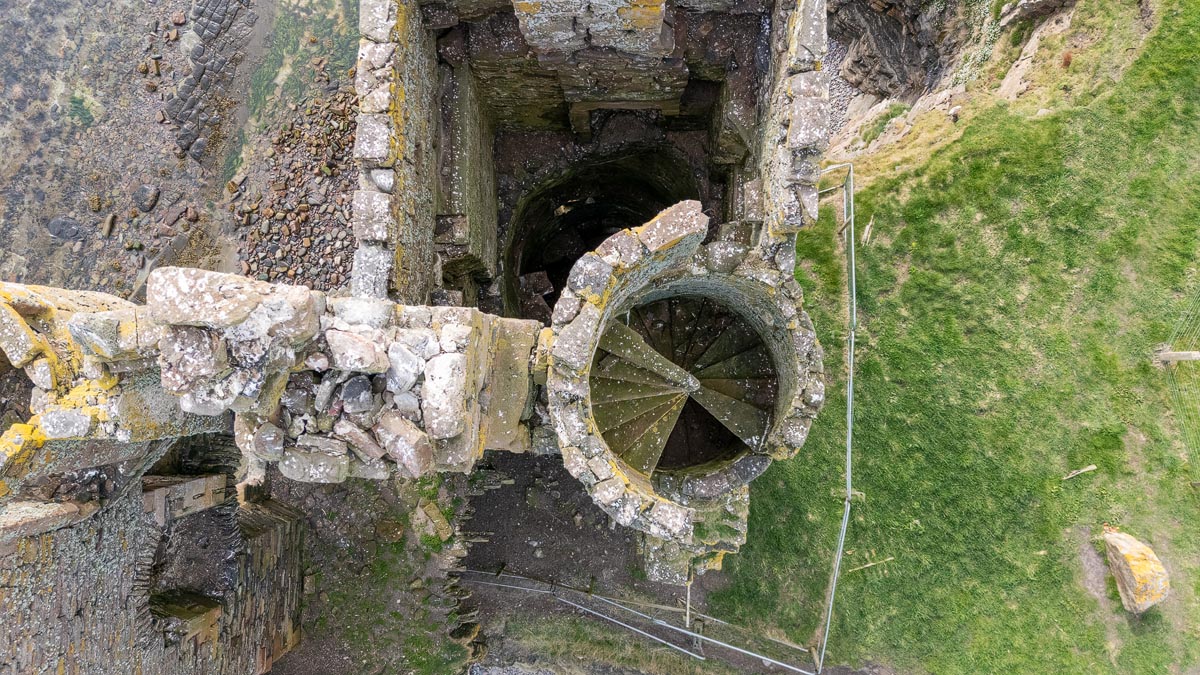 Drone view showing the preserved spiral staircase inside one of the round towers of Old Keiss Castle