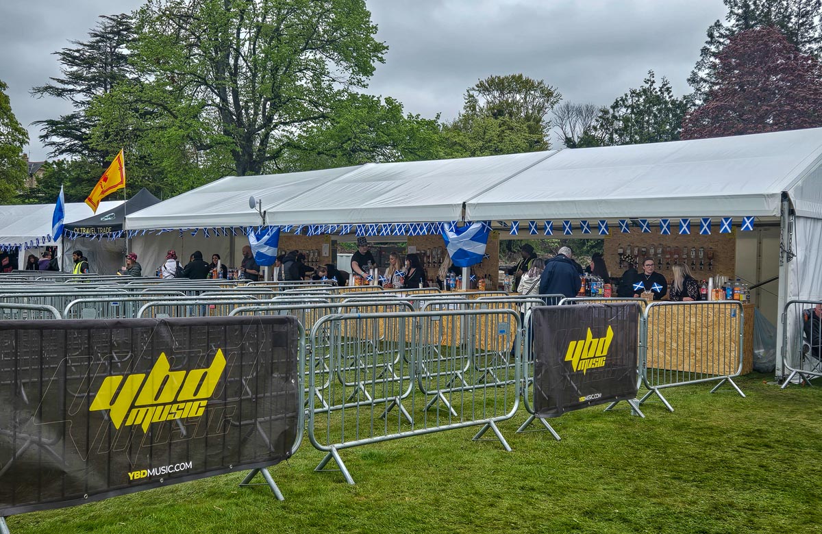 Large white marquee bar at MacMoray with Saltire bunting and YBD Music branded barriers