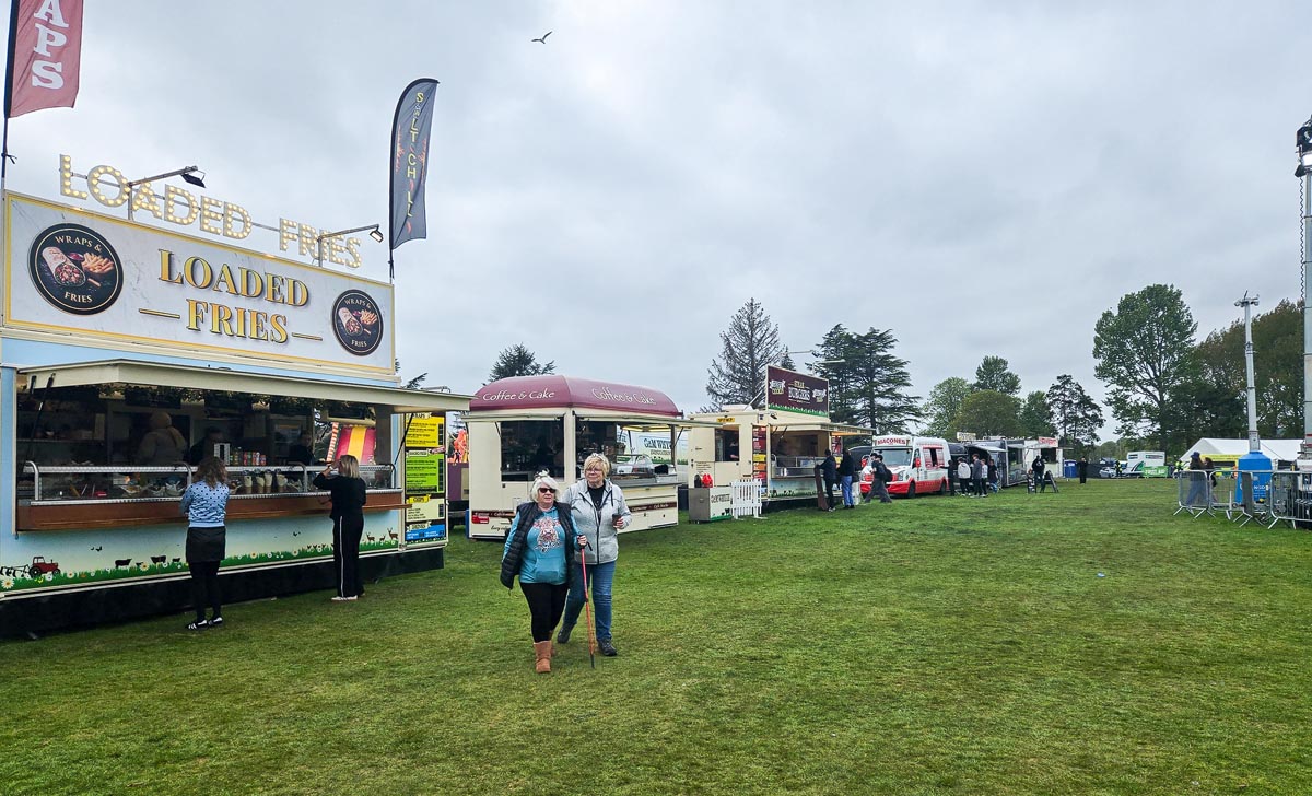 Wide view of the MacMoray food vendor area showing Loaded Fries, Coffee & Cake and other food trailers
