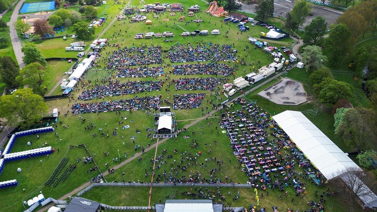 Aerial drone view of MacMoray Stage Two area with crowd, marquee and funfair visible