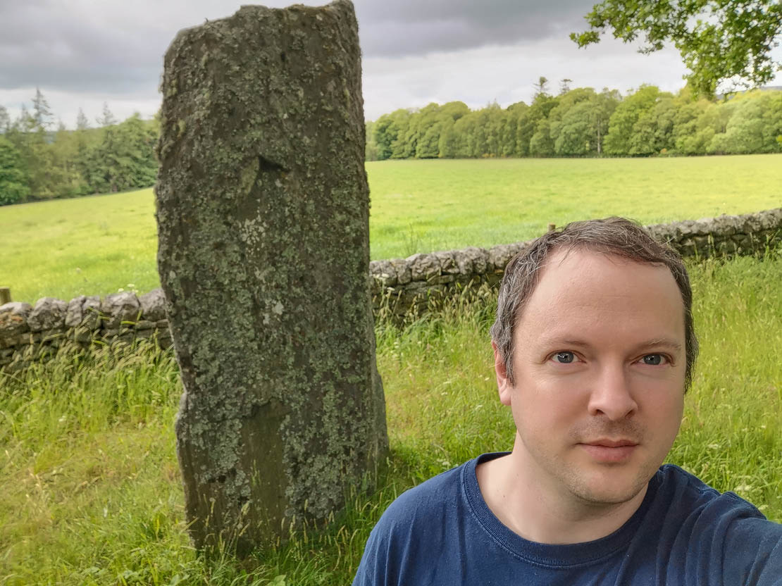 Chris and the large standing stone! Historic Environment Scotland.