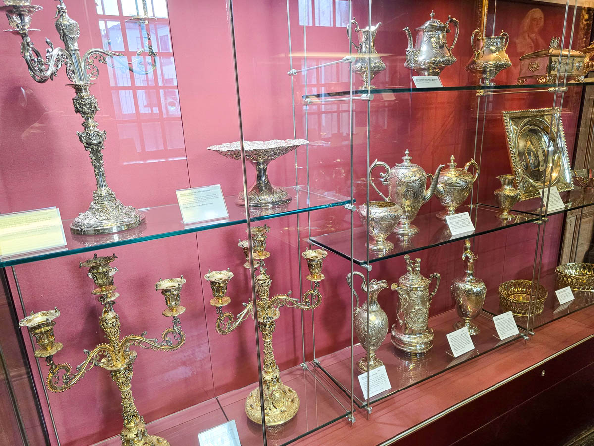 Close-up of ornate silver candelabras, teapots, ewers and decorative silverware at the Museum of Edinburgh