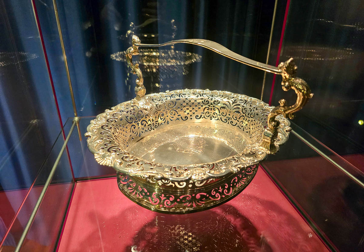 An exquisitely crafted pierced silver basket with an ornamental handle on display at the Museum of Edinburgh