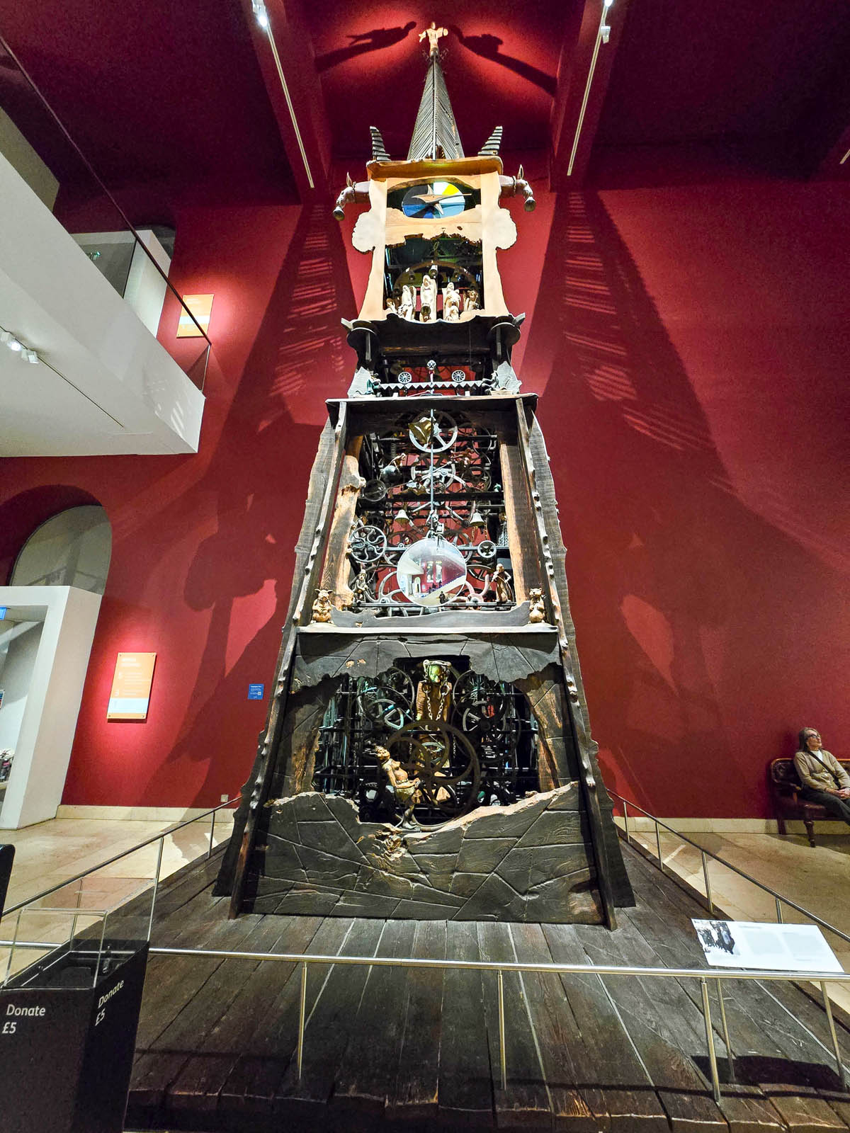 The Millennium Clock, a towering 10-metre mechanical sculpture with animated figures against a deep red wall