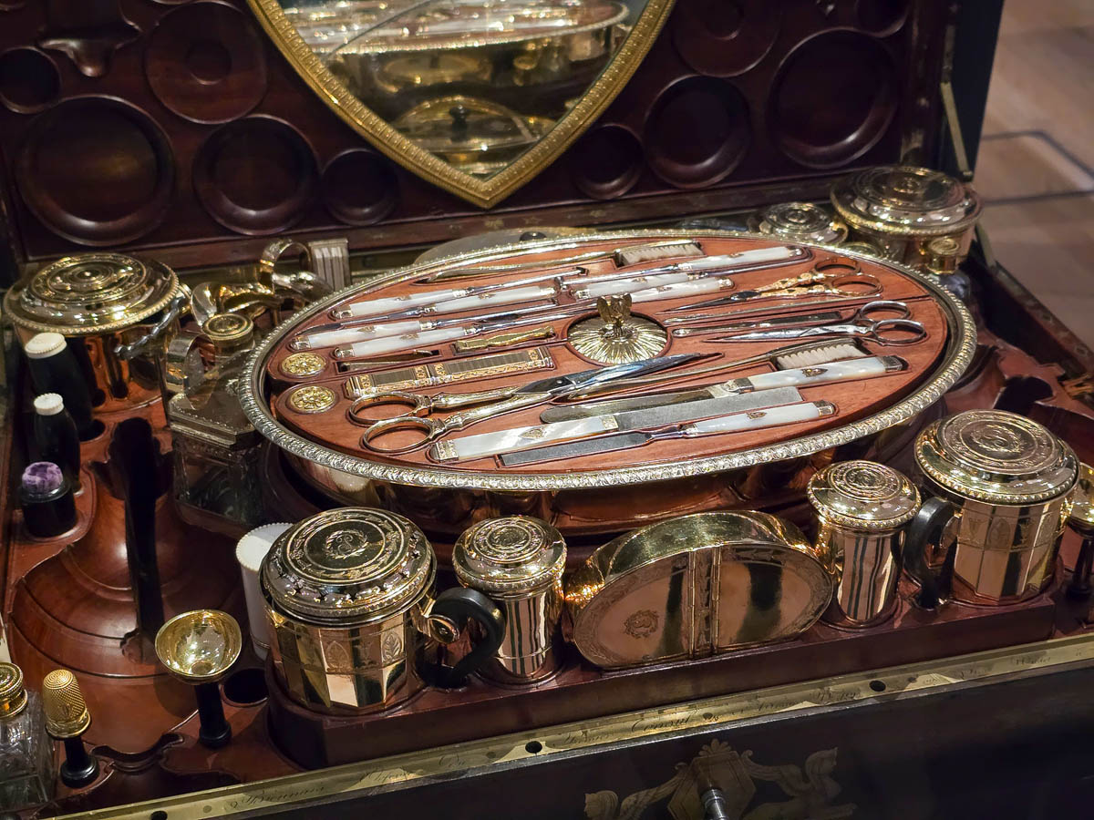 An ornate travelling vanity case with gold and silver fittings and mother of pearl implements