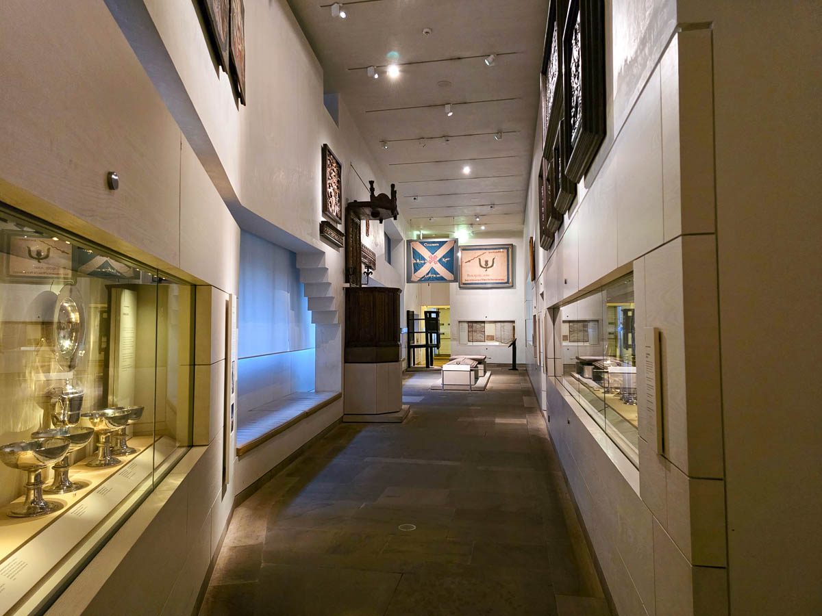 The Kingdom of the Scots gallery showing Scottish Saltire flags, communion ware, and historical documents