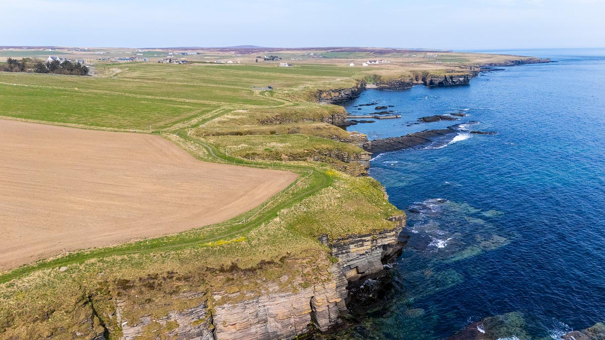 Aerial drone view of the Caithness coastline at Nybster looking north towards the car park and village of Auckengill