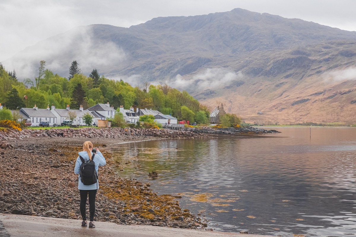 Whitewashed cottages along the shore at Inverie on Loch Nevis, Knoydart, with mist on the mountains behind