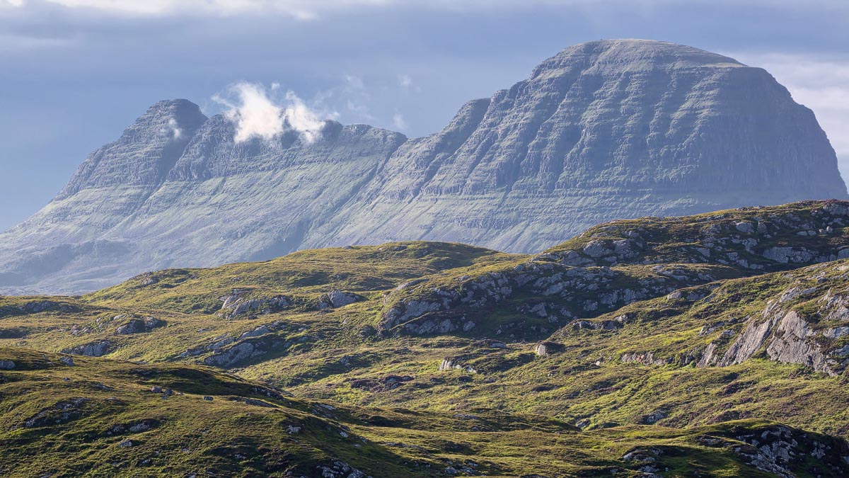 The distinctive barrel-shaped summit of Suilven rising above the rocky moorland of Assynt in the far northwest Highlands