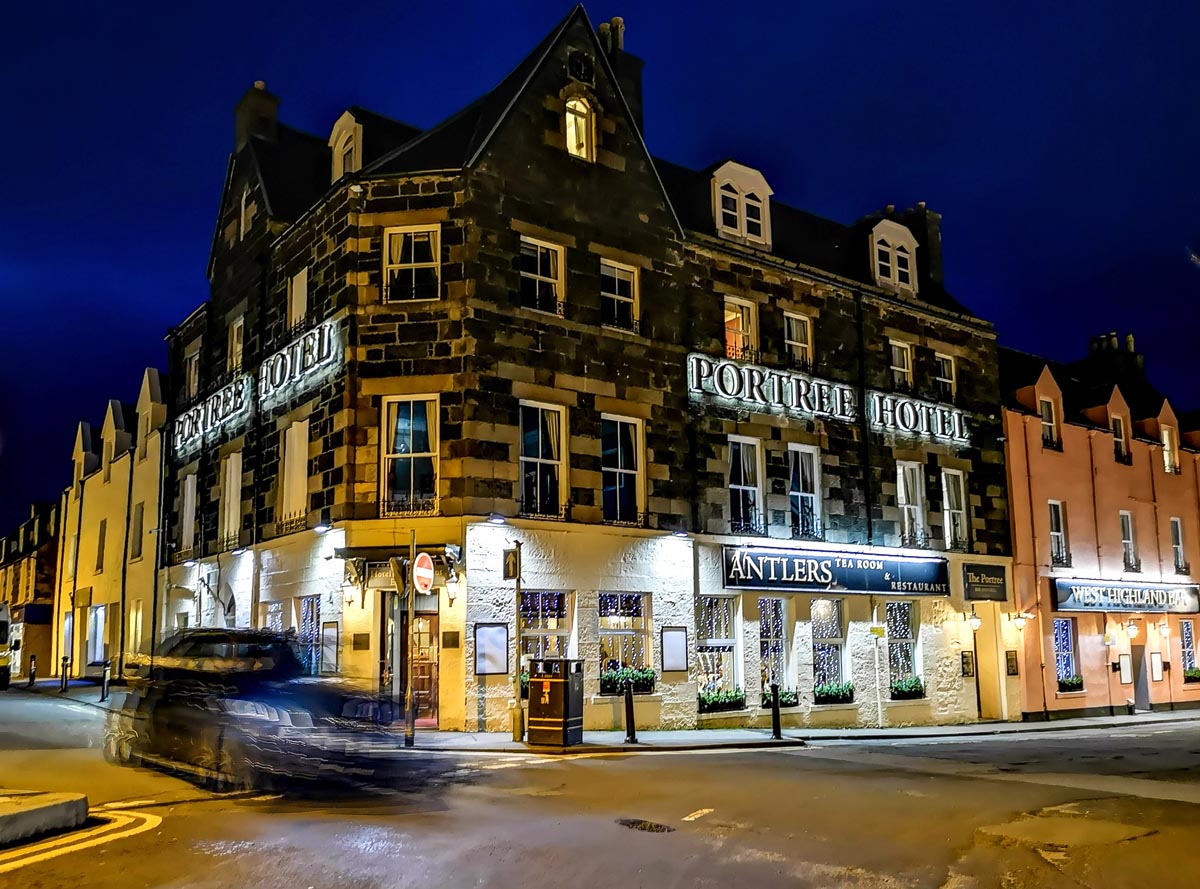The Portree Hotel and Antlers Tea Room illuminated at night on the Isle of Skye