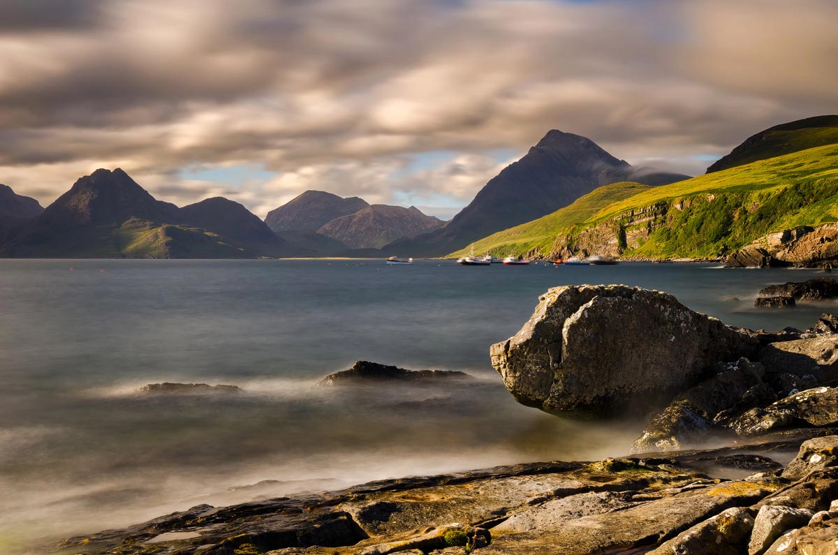 Long-exposure photograph from the rocky shore at Elgol looking across to the dramatic peaks of the Cuillin mountains on the Isle of Skye
