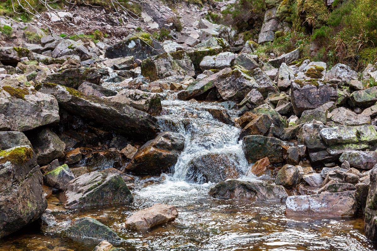 Water cascading over moss-covered rocks in the gorge below Wailing Widow Falls